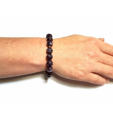 Woman wearing Handmade Refocusing Bracelet – Handmade Amethyst & Crown Chakra Crystal Bracelet on wrist